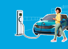 woman in front of her electric car while it's charging